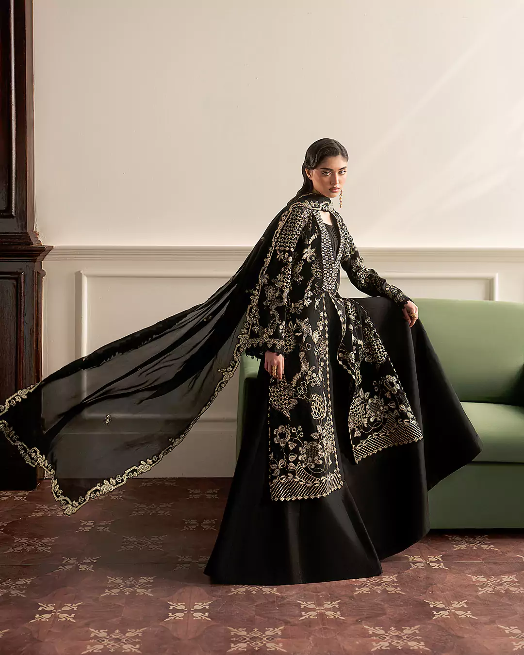 Female model showcasing detailed craftsmanship of Sirra Formals dress in fashion shoot
