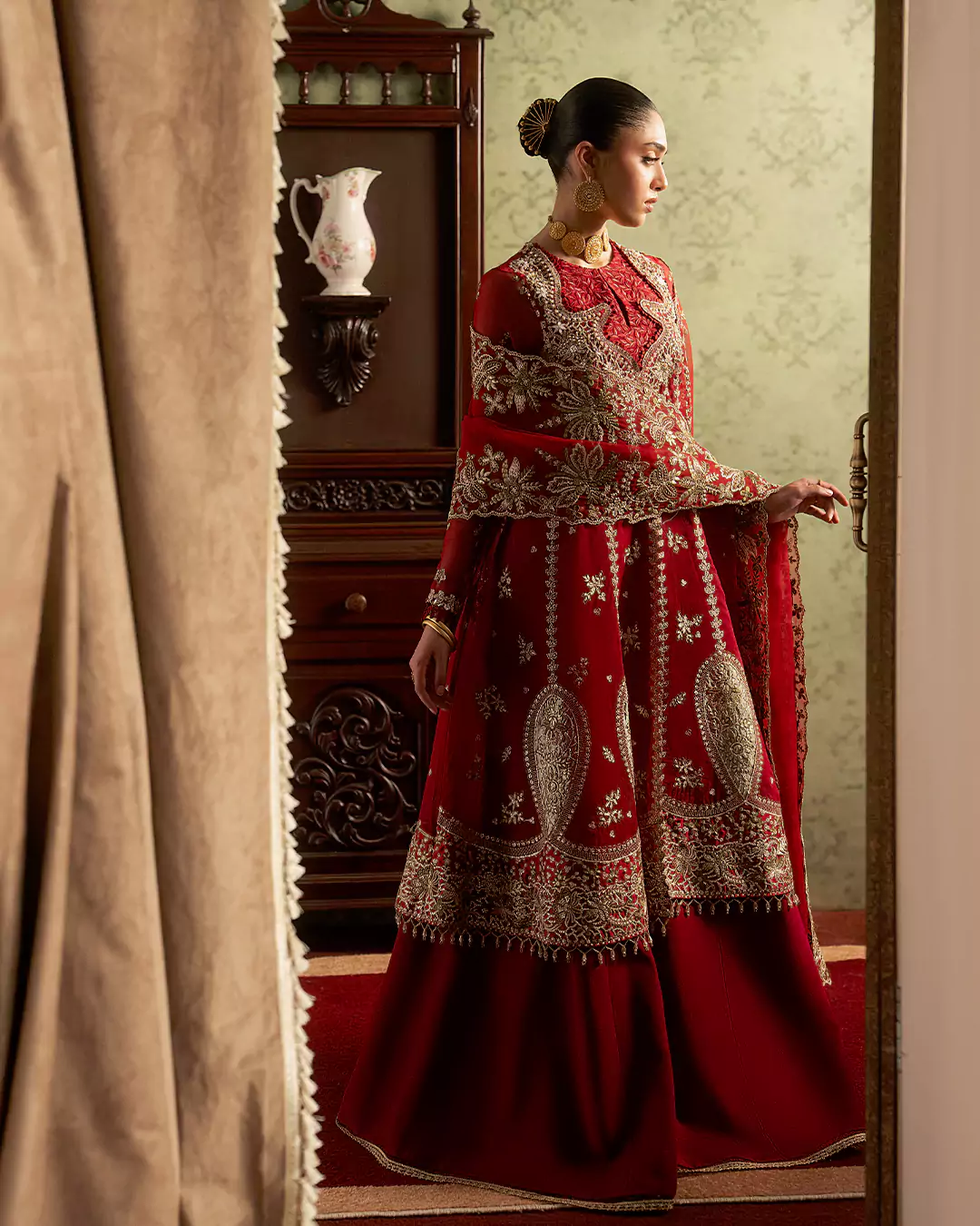 Elegant side pose of female model wearing Sirra Formals contemporary fashion design