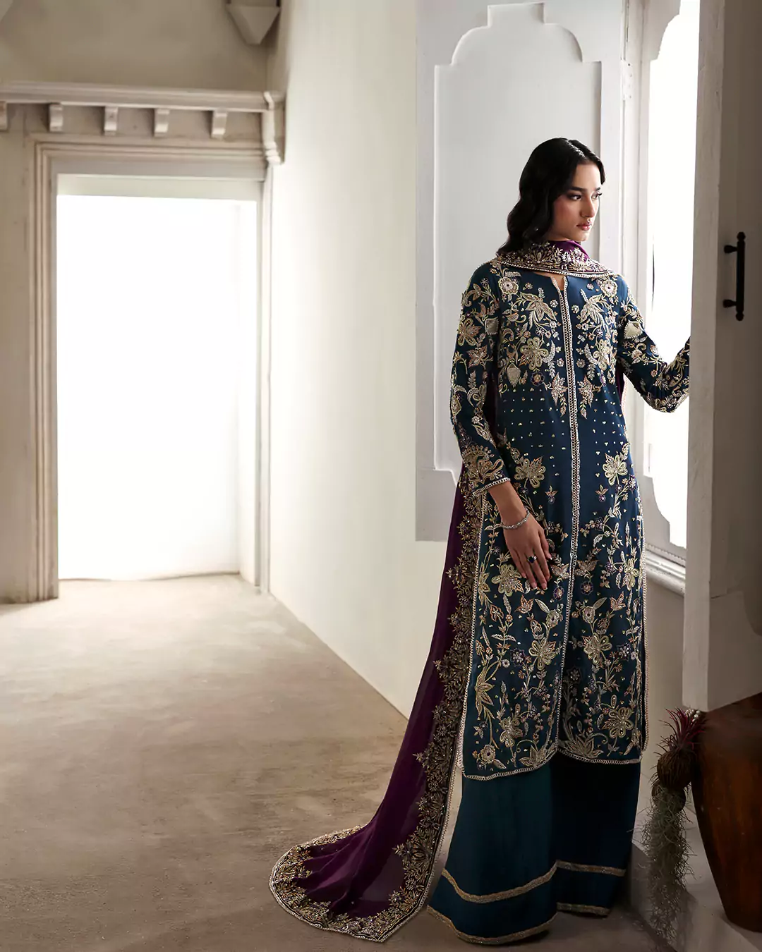 Model styled in festive wear photographed in soft golden hour lighting for luxury fashion campaign