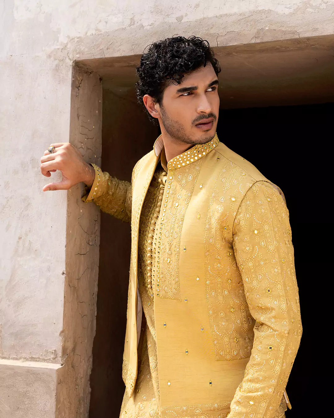 Model posing in contemporary festive menswear with structured silhouette for Hazure campaign