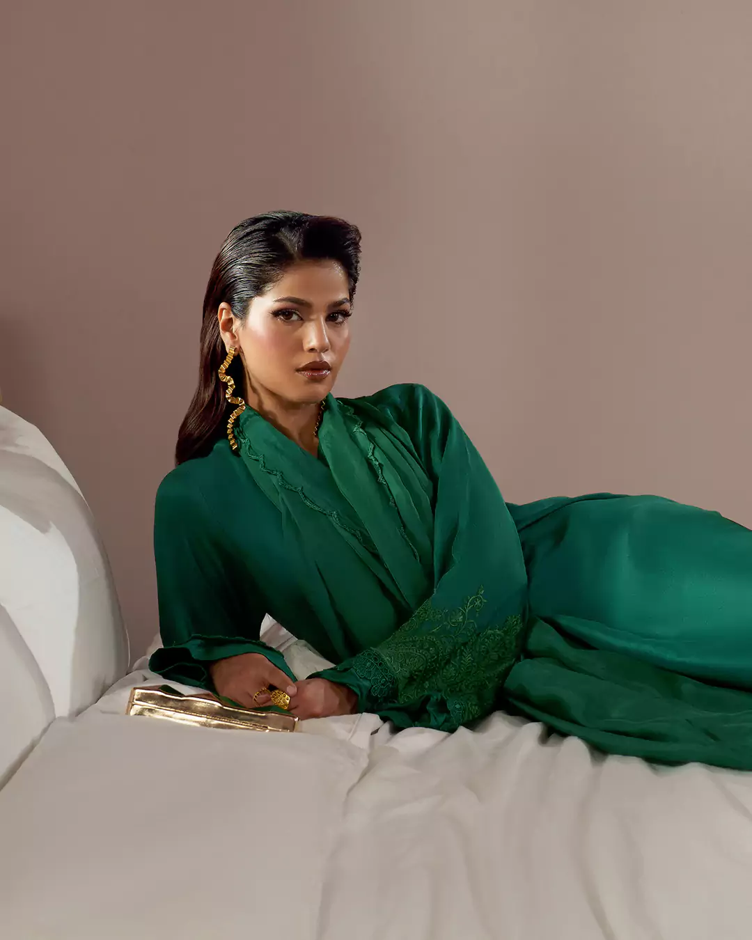 KALZARII Formals Collection portrait showcasing an elegant green formal outfit in an intimate interior setting