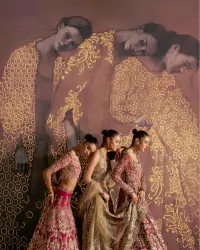 Luxury bridal couture editorial featuring three models in red and gold embroidered lehengas with artistic patterned backdrop. - Carousel Frame 13